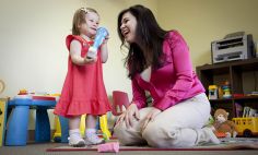 Karen Pierce, Ph.D., plays with a toddler referred to her program by a local pediatrician. 