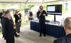 NIBIB Director Bruce J. Tromberg demonstrates a COVID-19 antigen test to a group of U.S. Senators on the NIH campus in Bethesda. The test was developed with support from NIH RADx Tech/ATP.